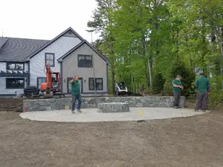 Crew building circular stone patio wall