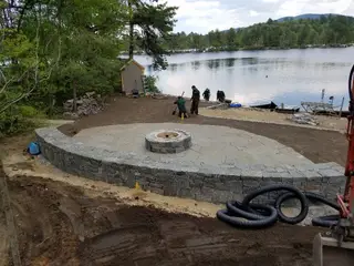 Crew finishing lakeside fire pit patio