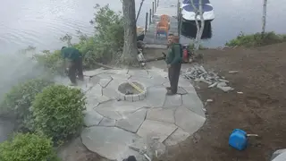 Crew finishing lakeside flagstone patio