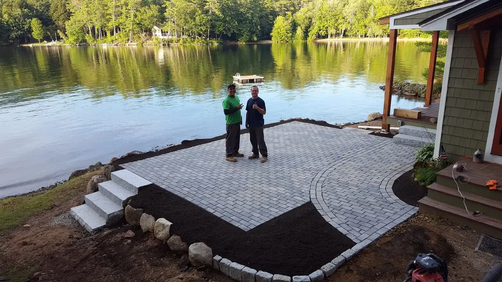 TLE crew on a finished lakeside paver patio