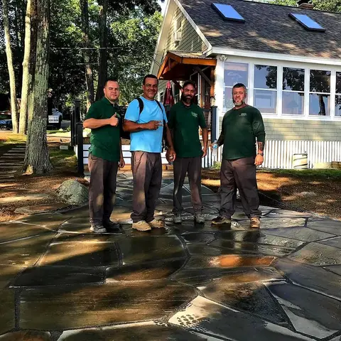 TLE crew posing on a finished flagstone patio