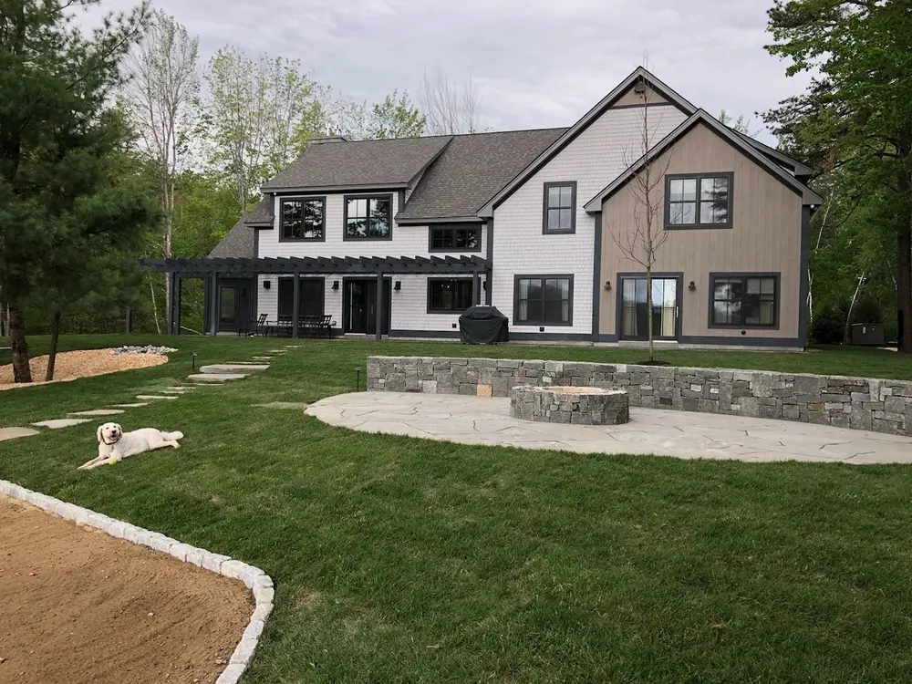 Slate patio and fire pit created through landscape design and installation