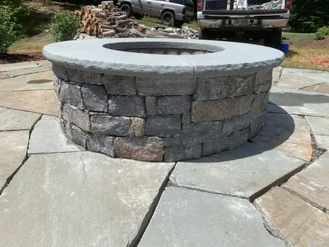 Outdoor stone fire pit built by our masonry crew